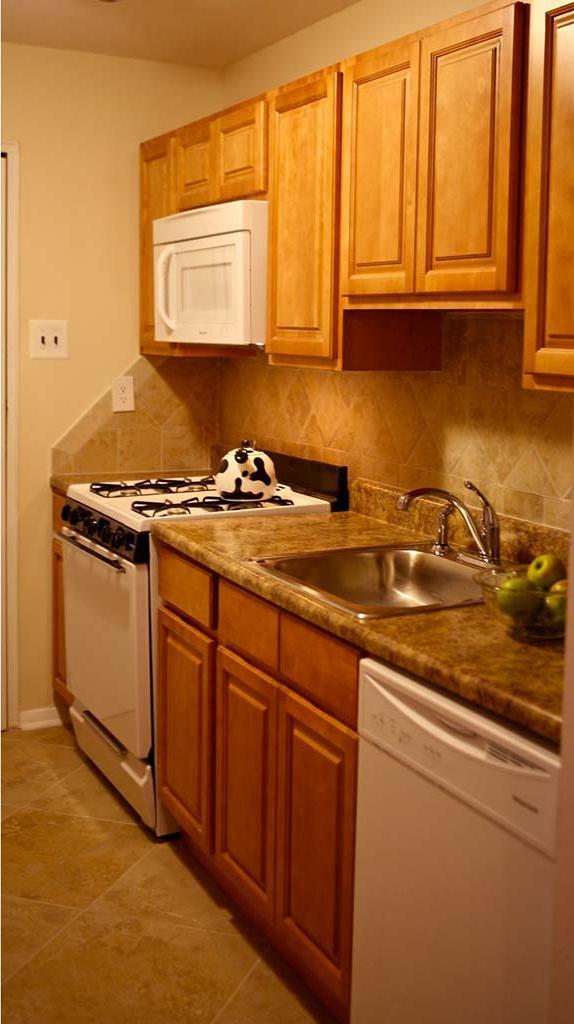 Kitchen with brown cabinetry at 约书亚的房子 apartments for rent in Philadelphia, PA